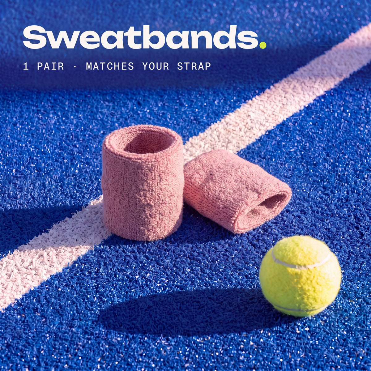 a pair of Blush Second Set sweatbands on a padel court, matching your strap.