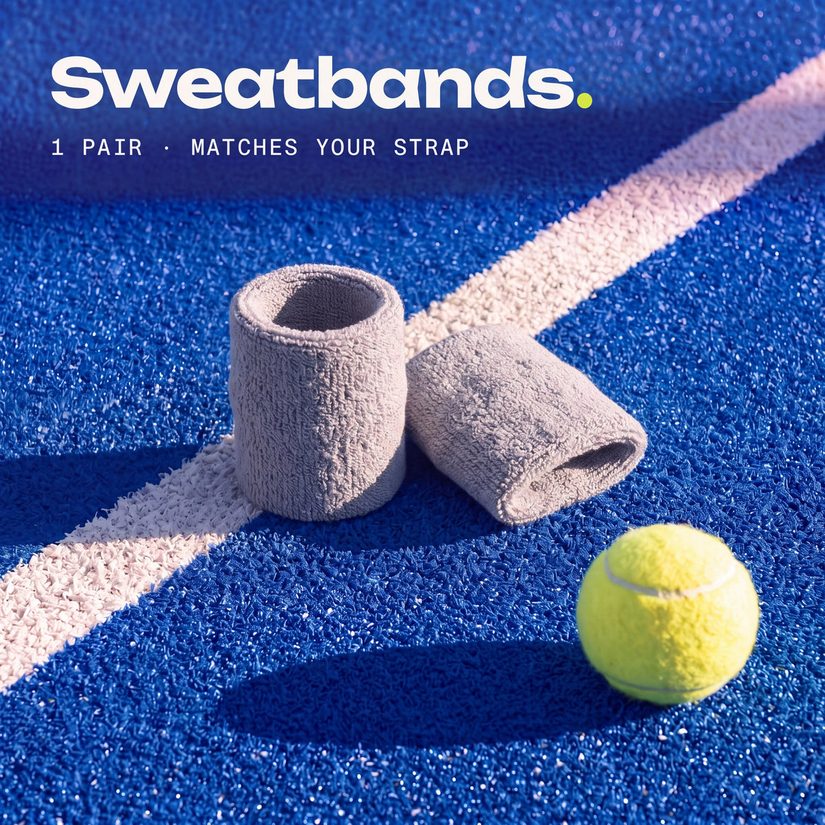 a pair of Chalk Second Set sweatbands on a padel court, matching your strap.
