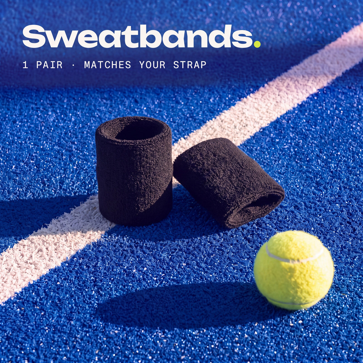 a pair of Ink Second Set sweatbands on a padel court, matching your strap.